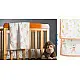 peach apricot block printed baby dohar blanket with whimsical monkey and bananas pattern draped over a crib