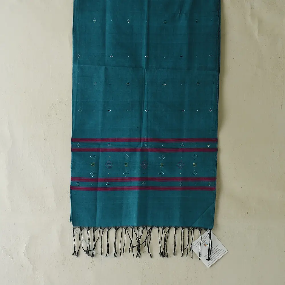 tangaliya handloom cotton stole in ocean teal blue with maroon red stripes, yellow and white raised dana bead motifs, and hand-knotted fringe tassels