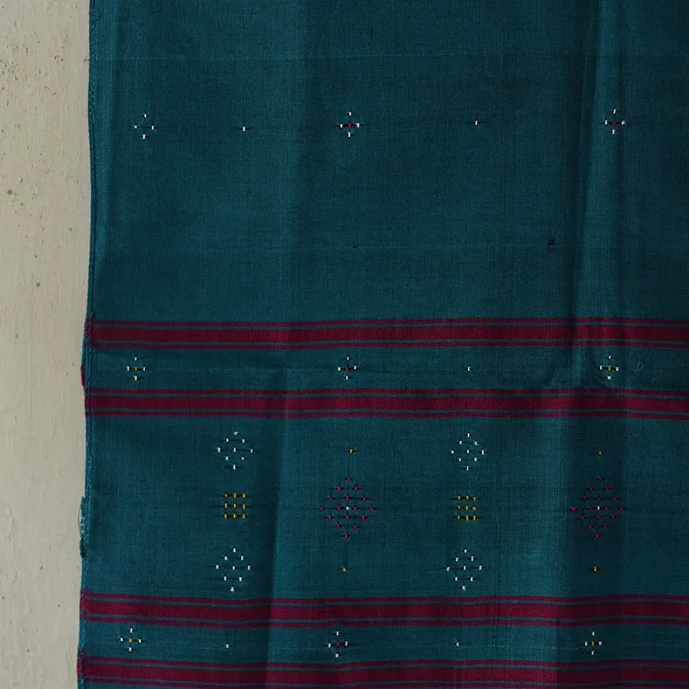 tangaliya handloom cotton stole in ocean teal blue with maroon red stripes, yellow and white raised dana bead motifs, and hand-knotted fringe tassels