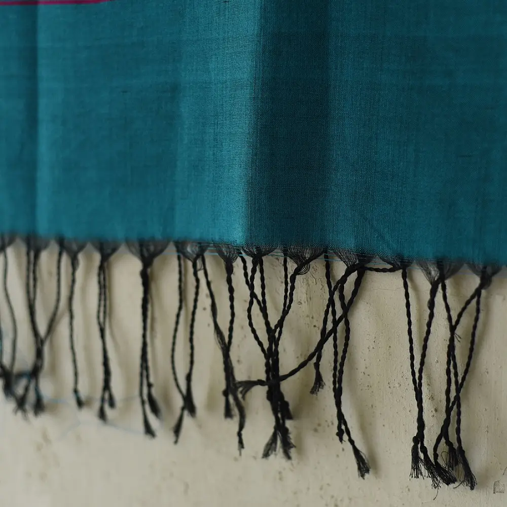 tangaliya handloom cotton stole in ocean teal blue with maroon red stripes, yellow and white raised dana bead motifs, and hand-knotted fringe tassels