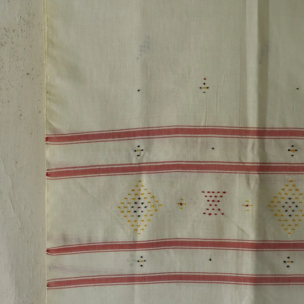 tangaliya handloom cotton stole in natural off-white cream with fine red pinstripes, yellow and red raised dana dot motifs, and fringe tassels