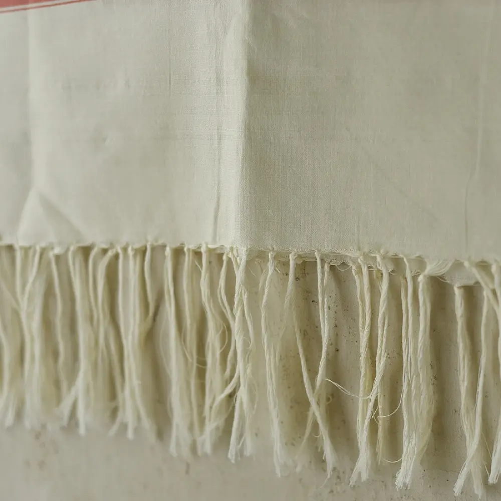 tangaliya handloom cotton stole in natural off-white cream with fine red pinstripes, yellow and red raised dana dot motifs, and fringe tassels