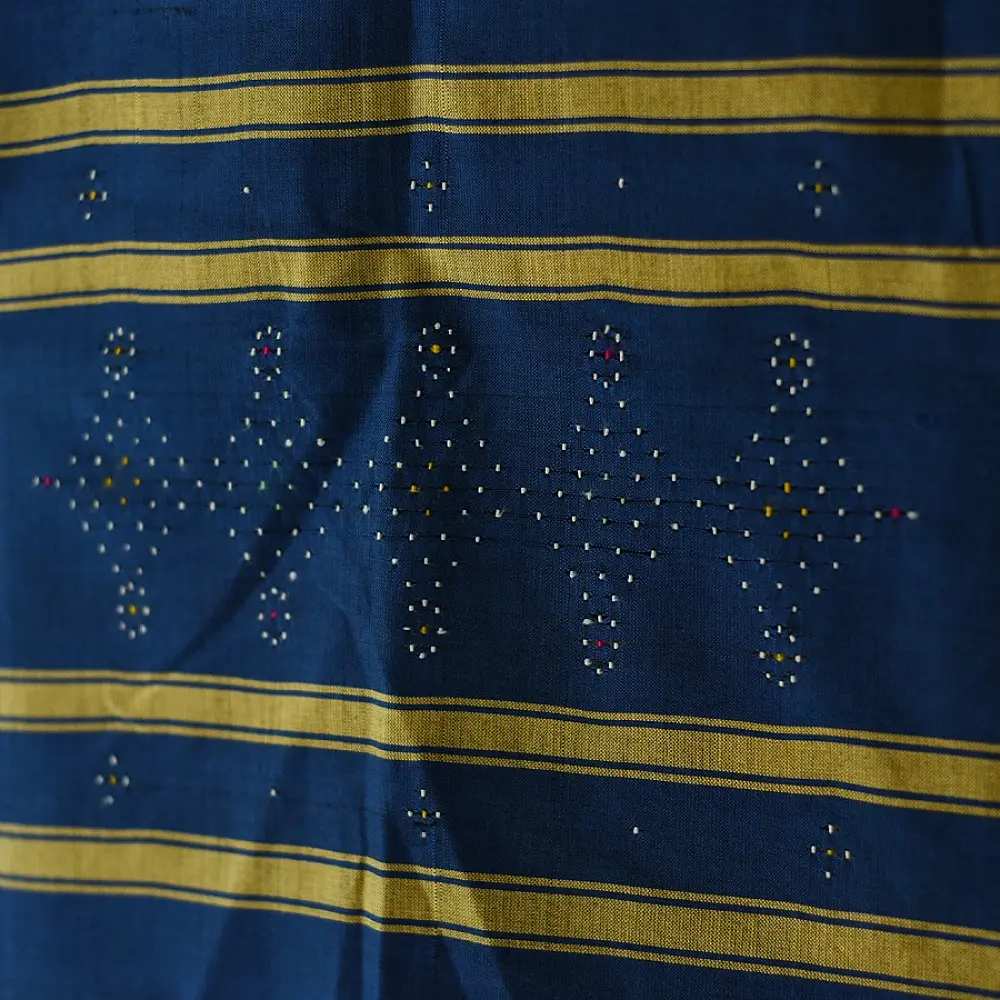 tangaliya handloom cotton stole in deep indigo blue with mustard yellow stripes, raised white dana dot motifs, and hand-knotted fringe tassels