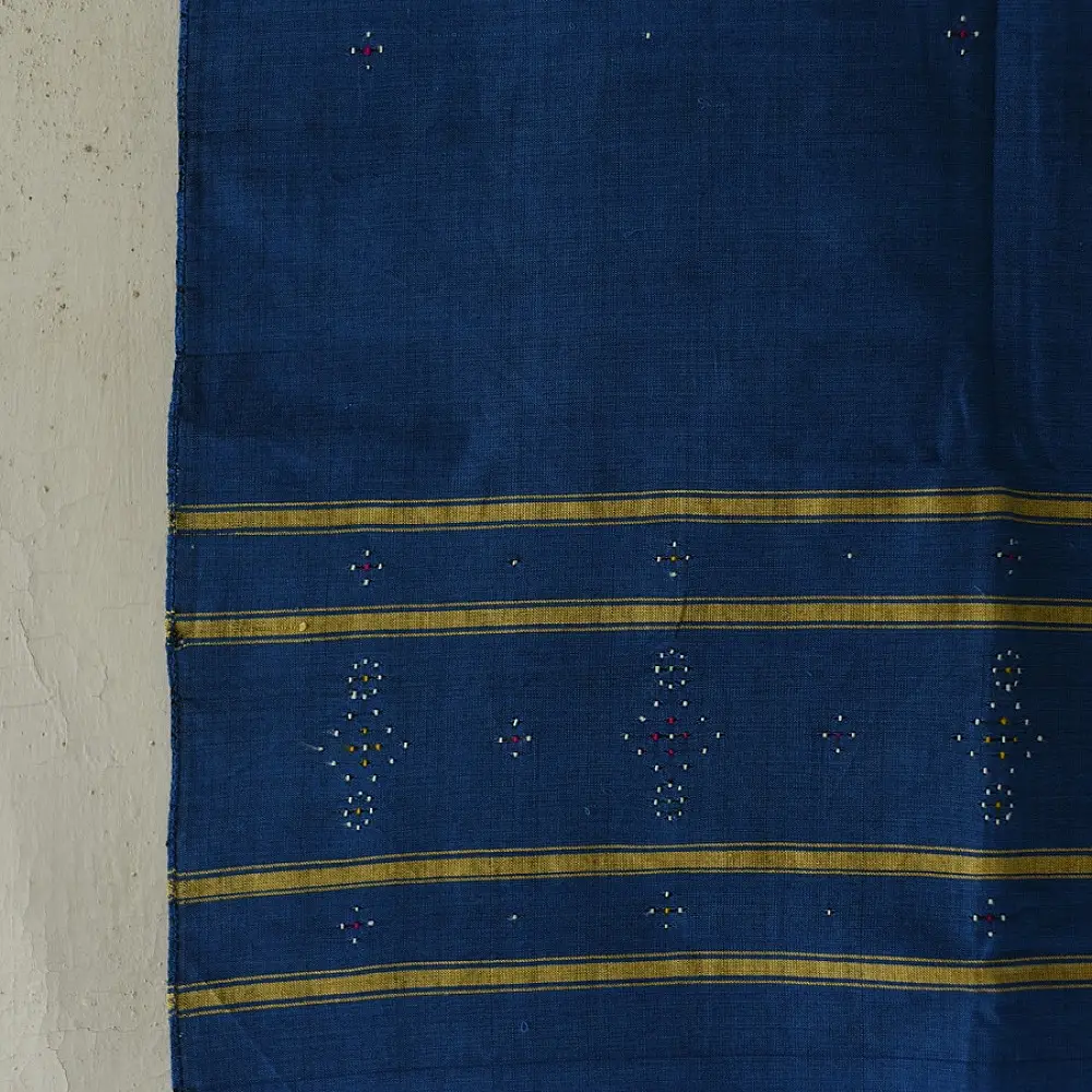 tangaliya handloom cotton stole in indigo royal blue with mustard yellow stripes, hand-woven white dana dot motifs, and knotted fringe tassels