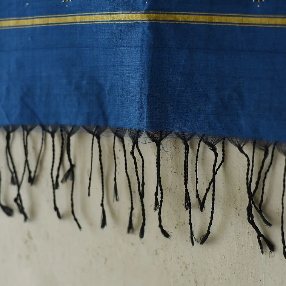 tangaliya handloom cotton stole in indigo royal blue with mustard yellow stripes, hand-woven white dana dot motifs, and knotted fringe tassels