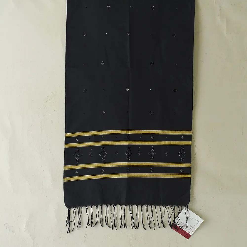 tangaliya handloom cotton stole in jet black, raised white and terracotta dana dots, and hand-knotted fringe tassels