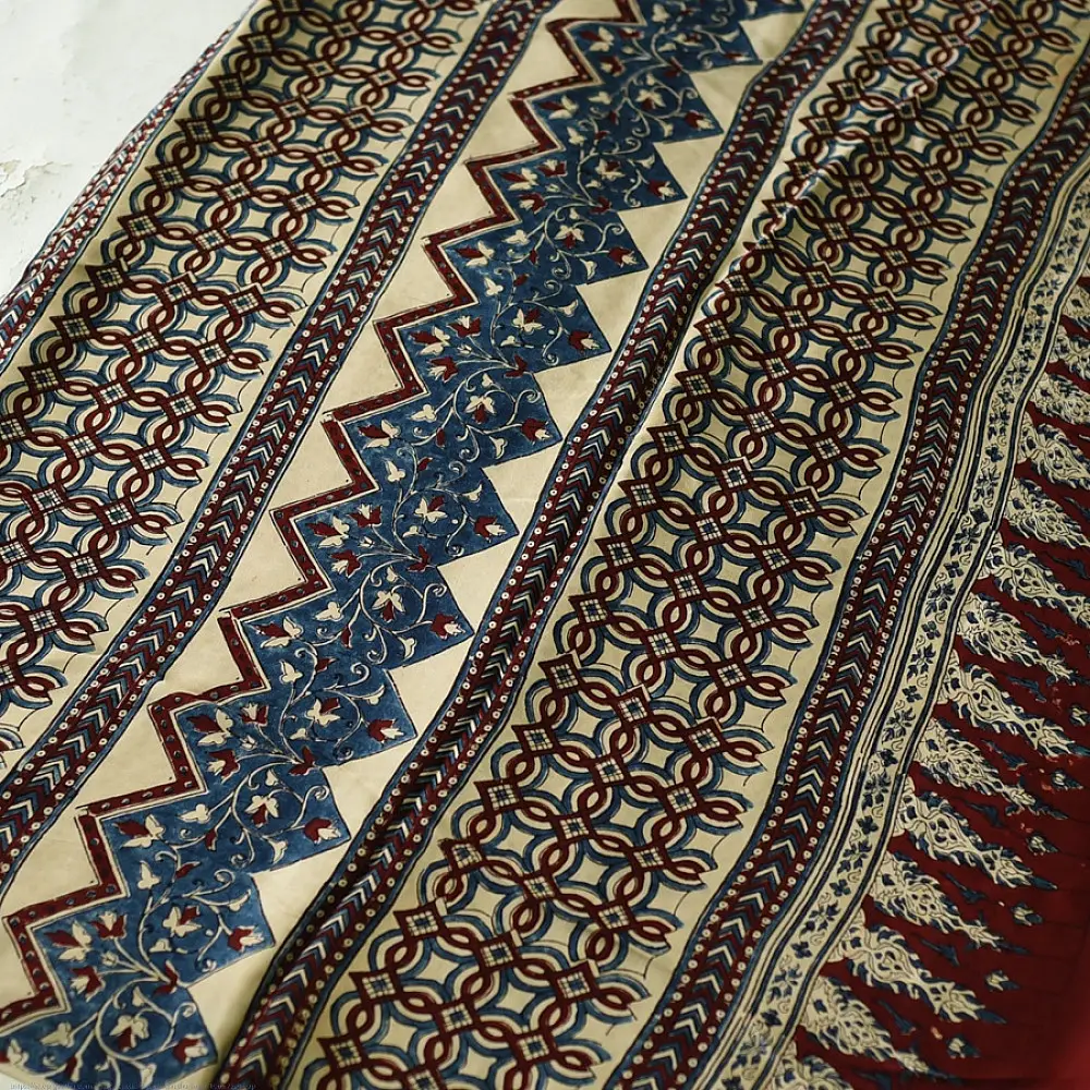 cream indigo blue madder red ajrakh cotton saree hand block printed floral vine pallu interlocking circular motifs traditional ethnic wear sustainable fashion natural dyed