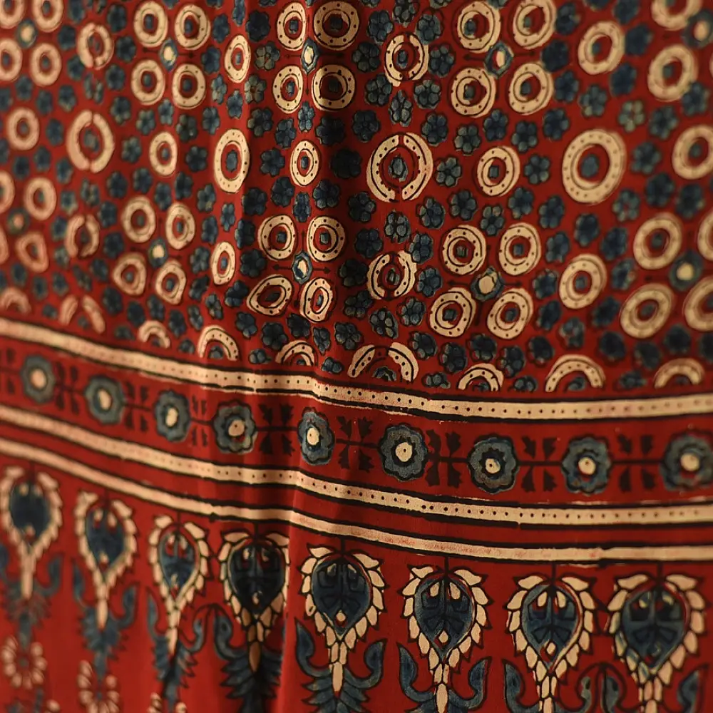 madder red indigo blue ajrakh modal silk dupatta hand block printed paisley kalka jaal body ornate circular bundi medallion pallu traditional mihrab arched detail wedding festive wear sustainable luxury natural dyed with tassels