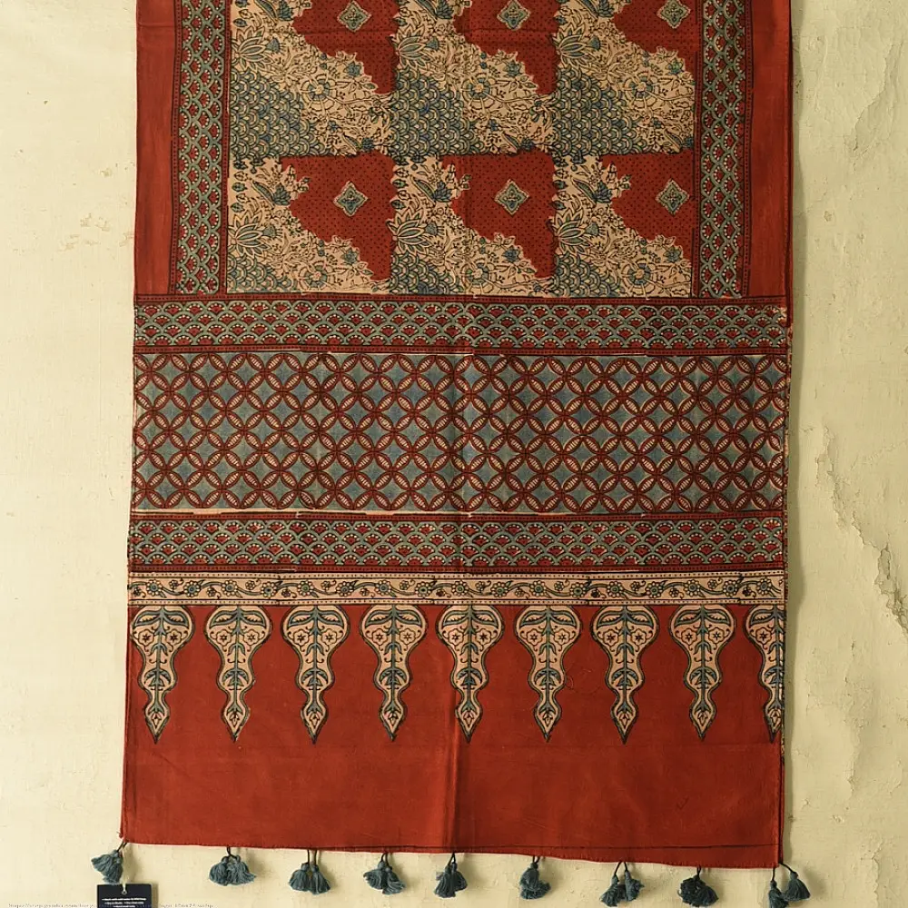 madder red indigo blue ajrakh cotton stole hand block printed checkerboard patchwork body ornate interlocking circular motifs mihrab arched border traditional artisanal scarf sustainable fashion natural dyed with tassels