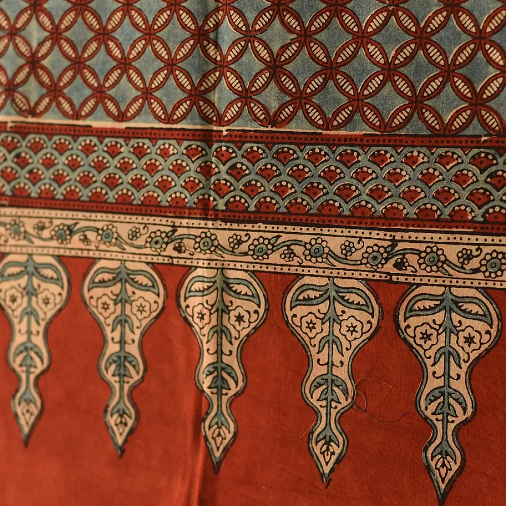 madder red indigo blue ajrakh cotton stole hand block printed checkerboard patchwork body ornate interlocking circular motifs mihrab arched border traditional artisanal scarf sustainable fashion natural dyed with tassels