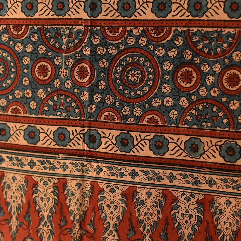terracotta madder red indigo blue ajrakh cotton stole hand block printed floral sprig body ornate circular mandala border traditional mihrab arched detail artisanal scarf sustainable fashion natural dyed with tassels