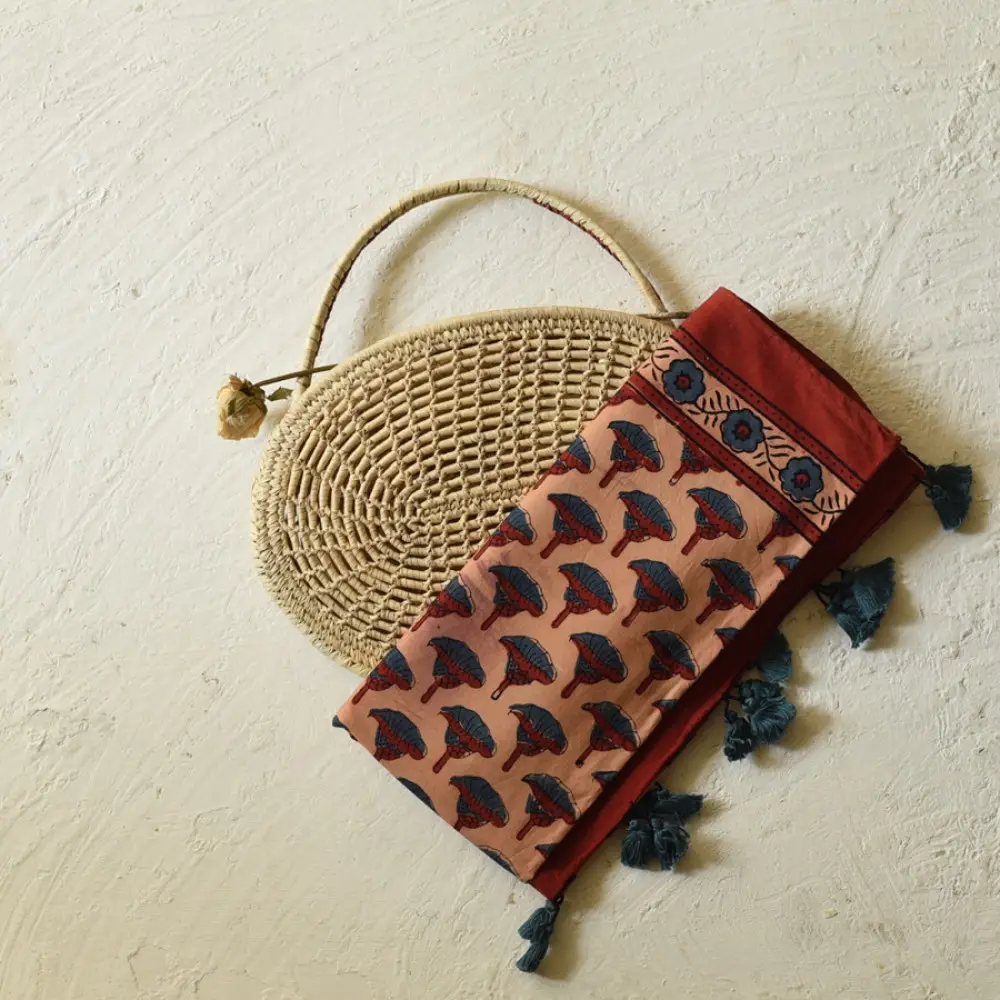 terracotta madder red indigo blue ajrakh cotton stole hand block printed floral sprig body ornate circular mandala border traditional mihrab arched detail artisanal scarf sustainable fashion natural dyed with tassels