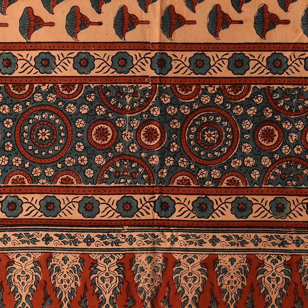 terracotta madder red indigo blue ajrakh cotton stole hand block printed floral sprig body ornate circular mandala border traditional mihrab arched detail artisanal scarf sustainable fashion natural dyed with tassels