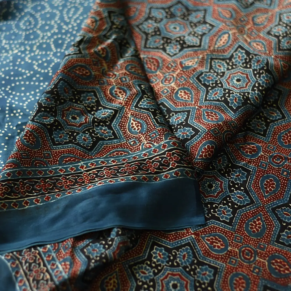 deep indigo blue madder red ajrakh modal silk saree hand block printed octagonal star jaal ornate floral mandala pallu traditional ethnic wear sustainable luxury natural dyed with tassels