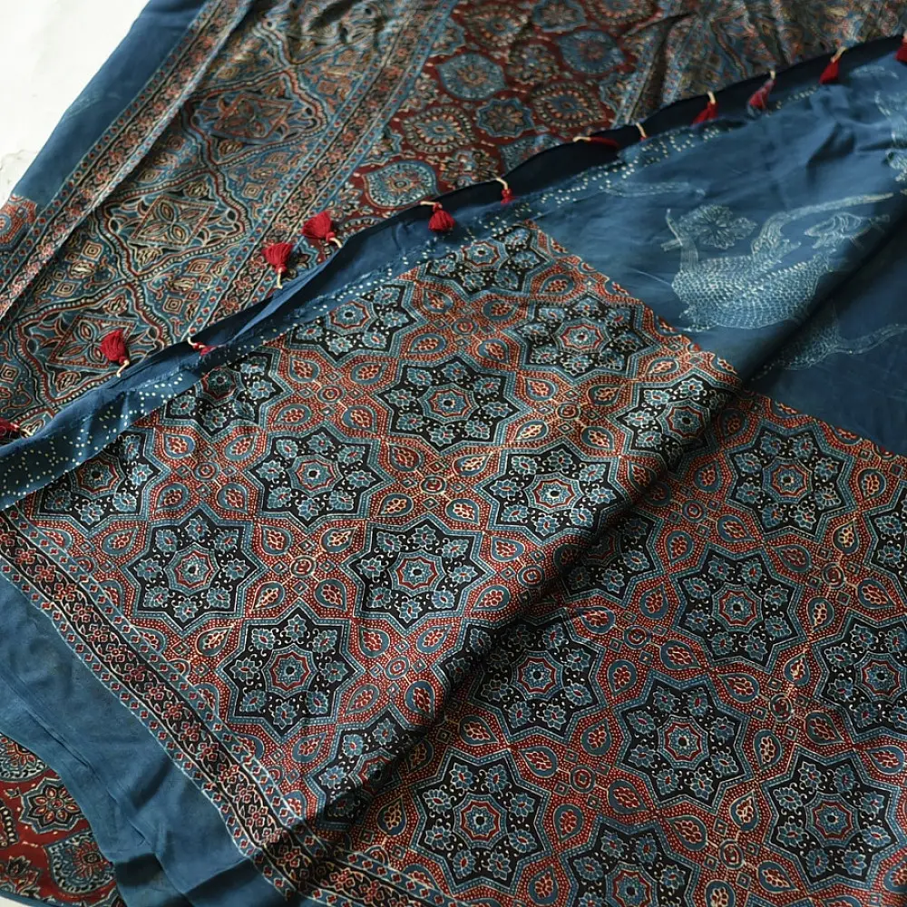 deep indigo blue madder red ajrakh modal silk saree hand block printed octagonal star jaal ornate floral mandala pallu traditional ethnic wear sustainable luxury natural dyed with tassels