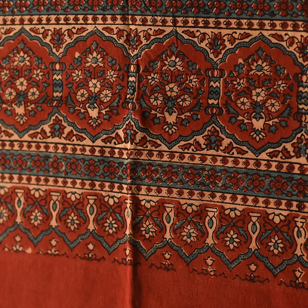 terracotta madder red ajrakh cotton stole hand block printed large circular chand moon medallion geometric lattice body ornate floral mihrab border traditional artisanal scarf sustainable fashion natural dyed with tassels