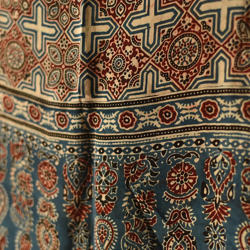deep indigo blue madder red ajrakh modal silk dupatta hand block printed floral medallion jaal body ornate cross-lattice pallu traditional mihrab arched detail wedding festive wear sustainable luxury natural dyed with tassels