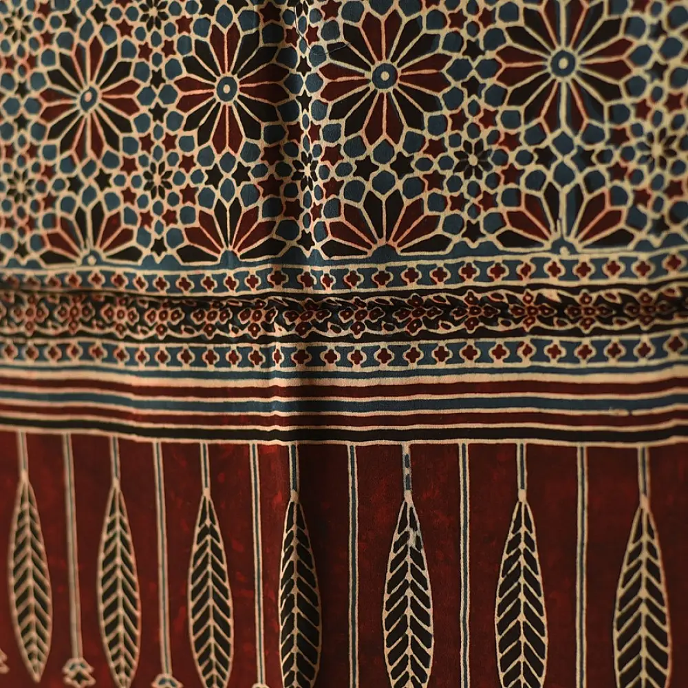 deep indigo blue madder red ajrakh silk stole hand block printed floral buta motif body ornate star medallion border traditional mihrab arched detail artisanal scarf sustainable fashion natural dyed with tassels