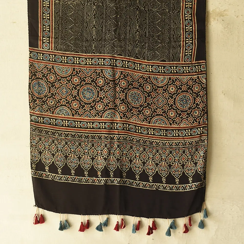 black gold ajrakh cotton stole hand block printed bundi tiny dot body ornate circular mandala border traditional mihrab arched detail artisanal scarf sustainable fashion natural dyed with tassels