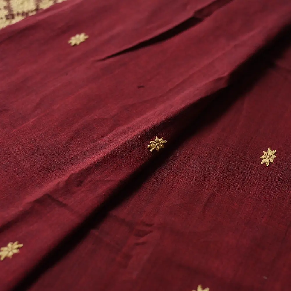 maroon red handloom traditional assam cotton saree with small gold star butta motifs and triangular border weaves for women
