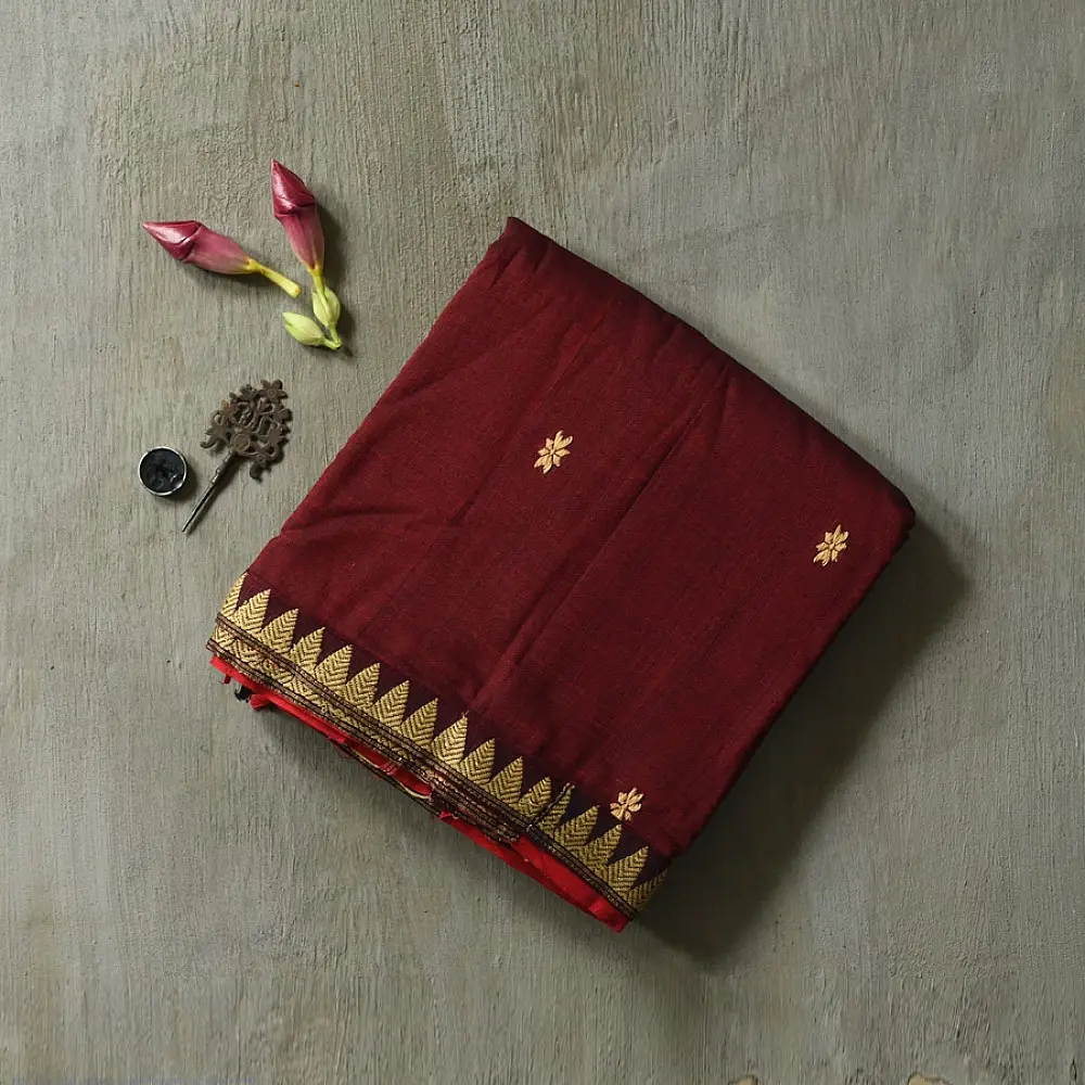 maroon red handloom traditional assam cotton saree with small gold star butta motifs and triangular border weaves for women
