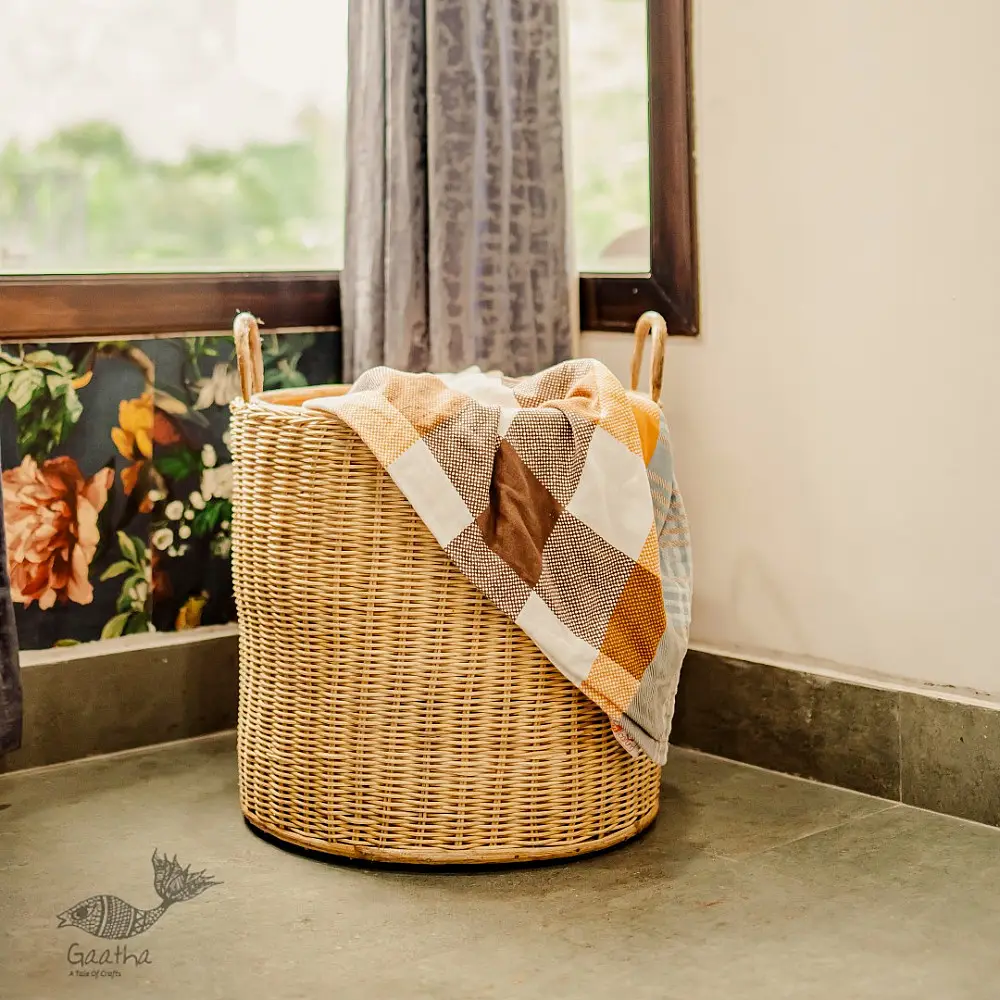 handmade natural wicker laundry basket with sturdy loop handles and woven cane texture