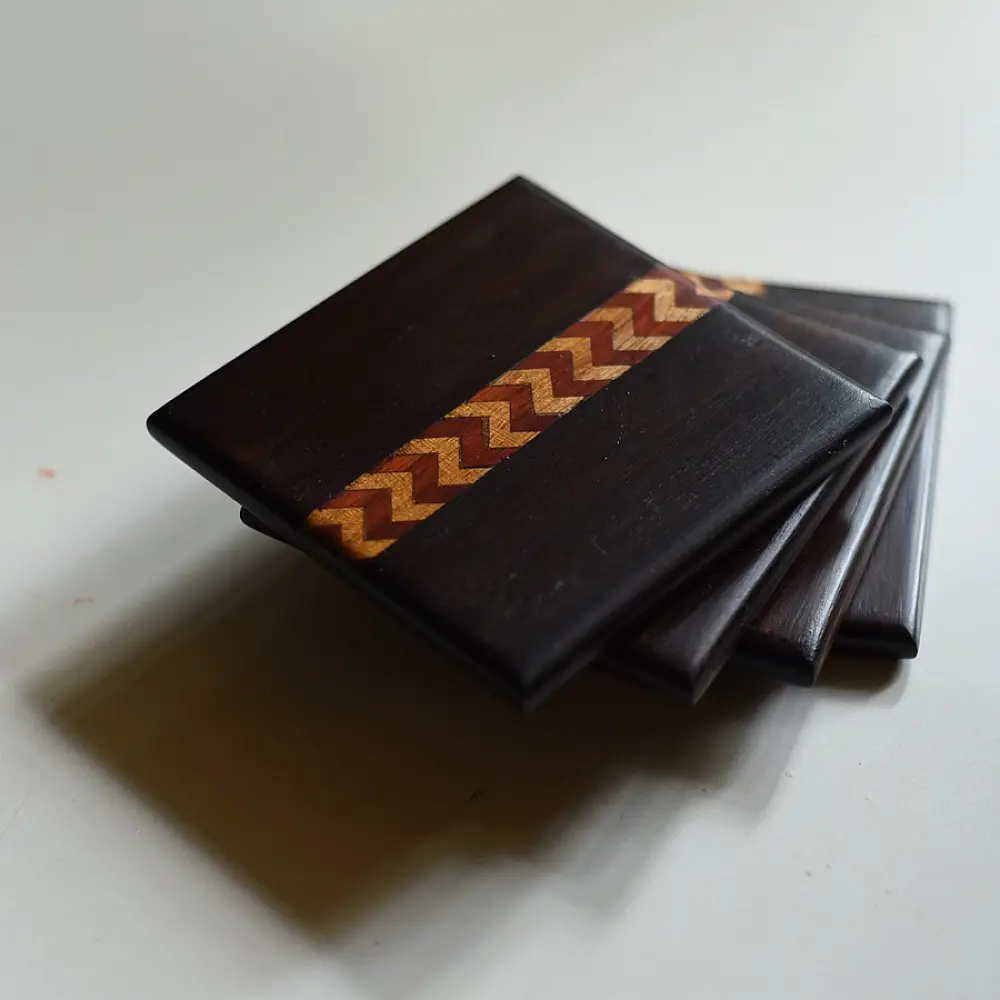 handmade dark wood coasters set of four with zigzag wooden inlay design