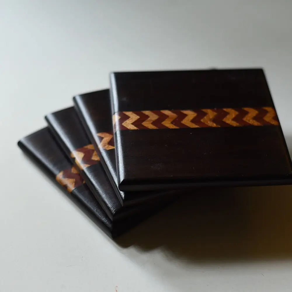handmade dark wood coasters set of four with zigzag wooden inlay design