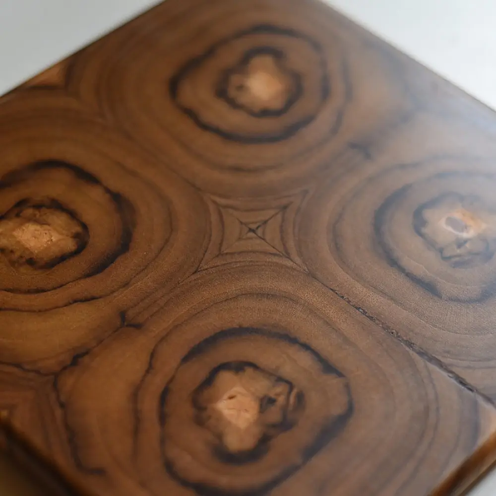 handmade wooden trivet with carved circular quadrant pattern