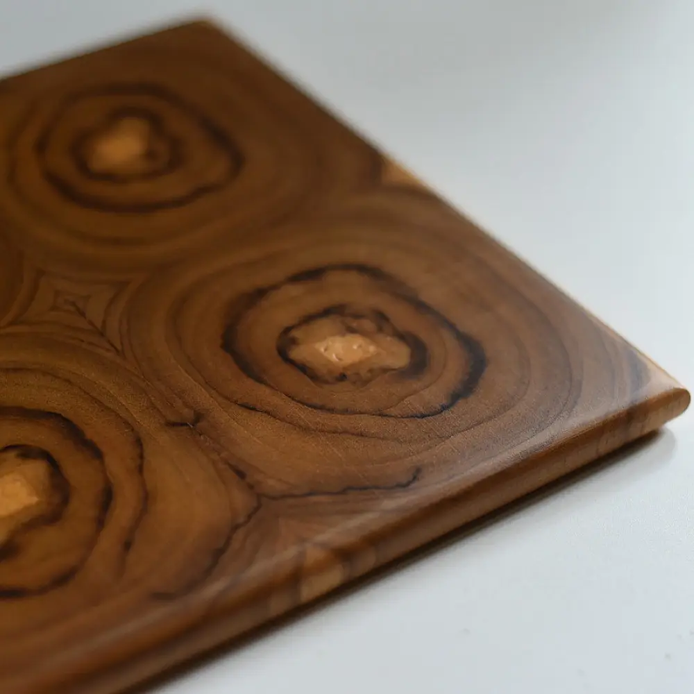 handmade wooden trivet with carved circular quadrant pattern