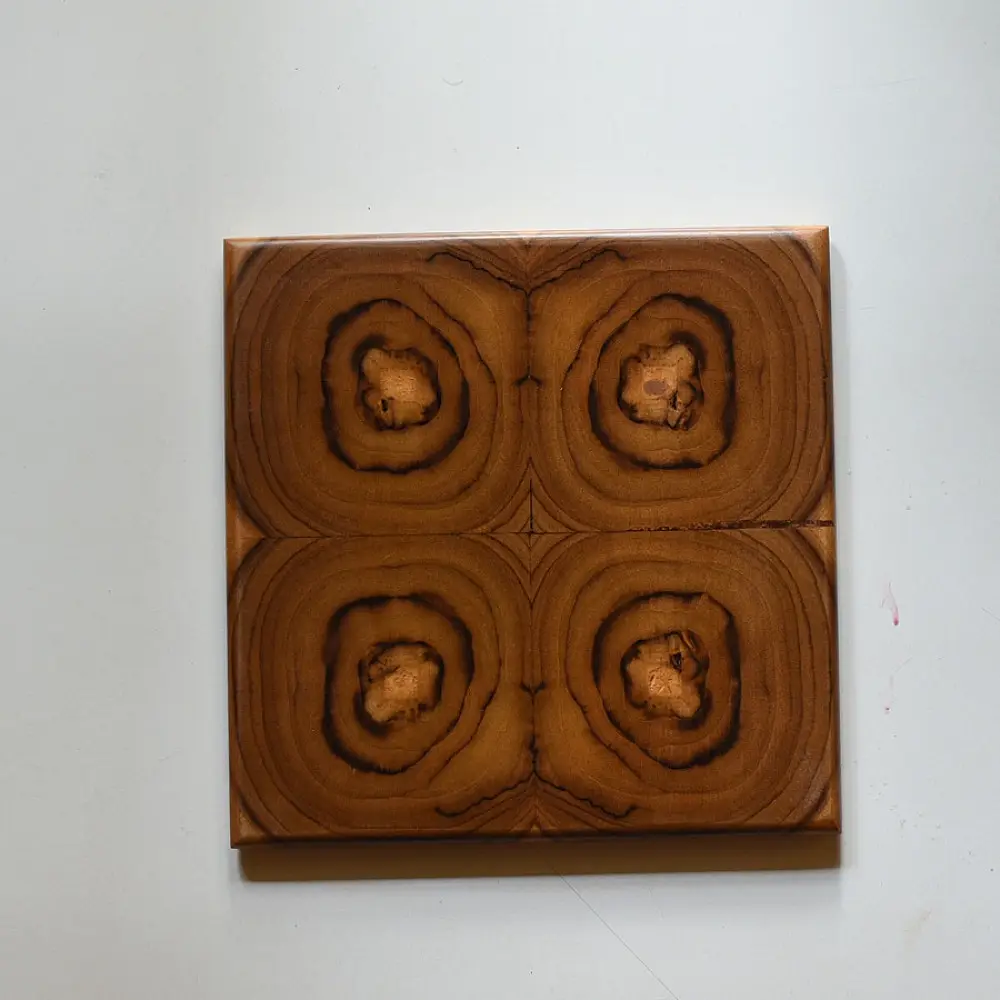 handmade wooden trivet with carved circular quadrant pattern