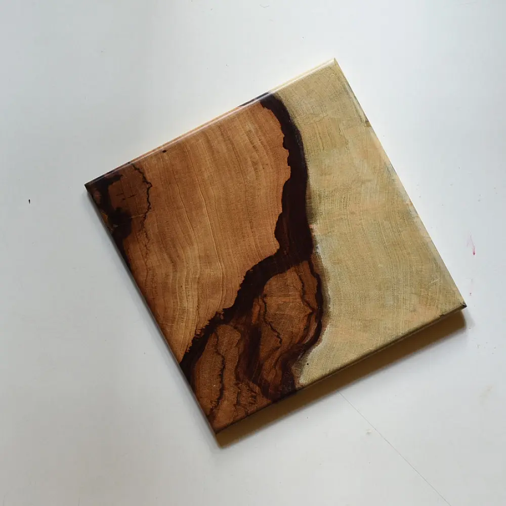 handmade wooden trivet with natural grain pattern and epoxy inlay