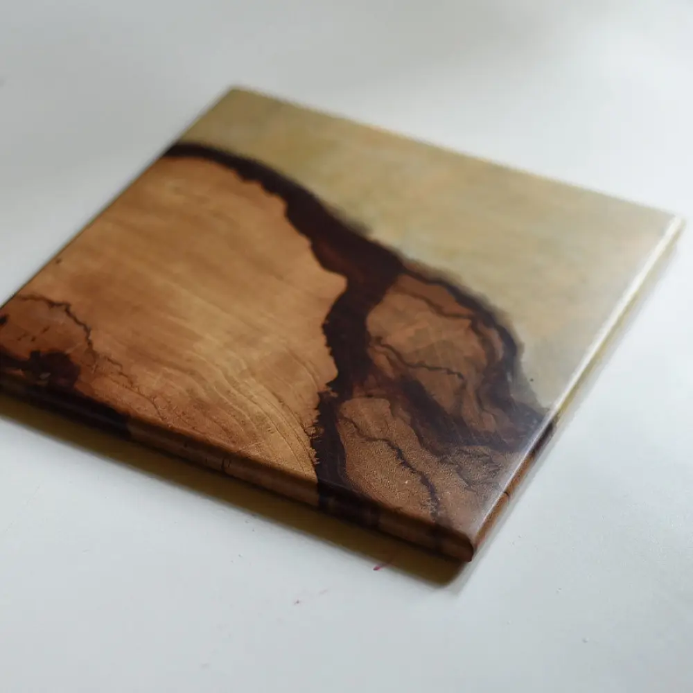 handmade wooden trivet with natural grain pattern and epoxy inlay