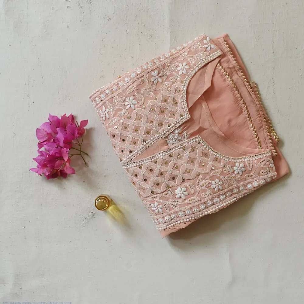 semi stitched viscose georgette kurti in delicate peach color featuring fine hand embroidered chikankari lattice yoke and all over floral motifs paired with a mukaish and lace detailed dupatta
