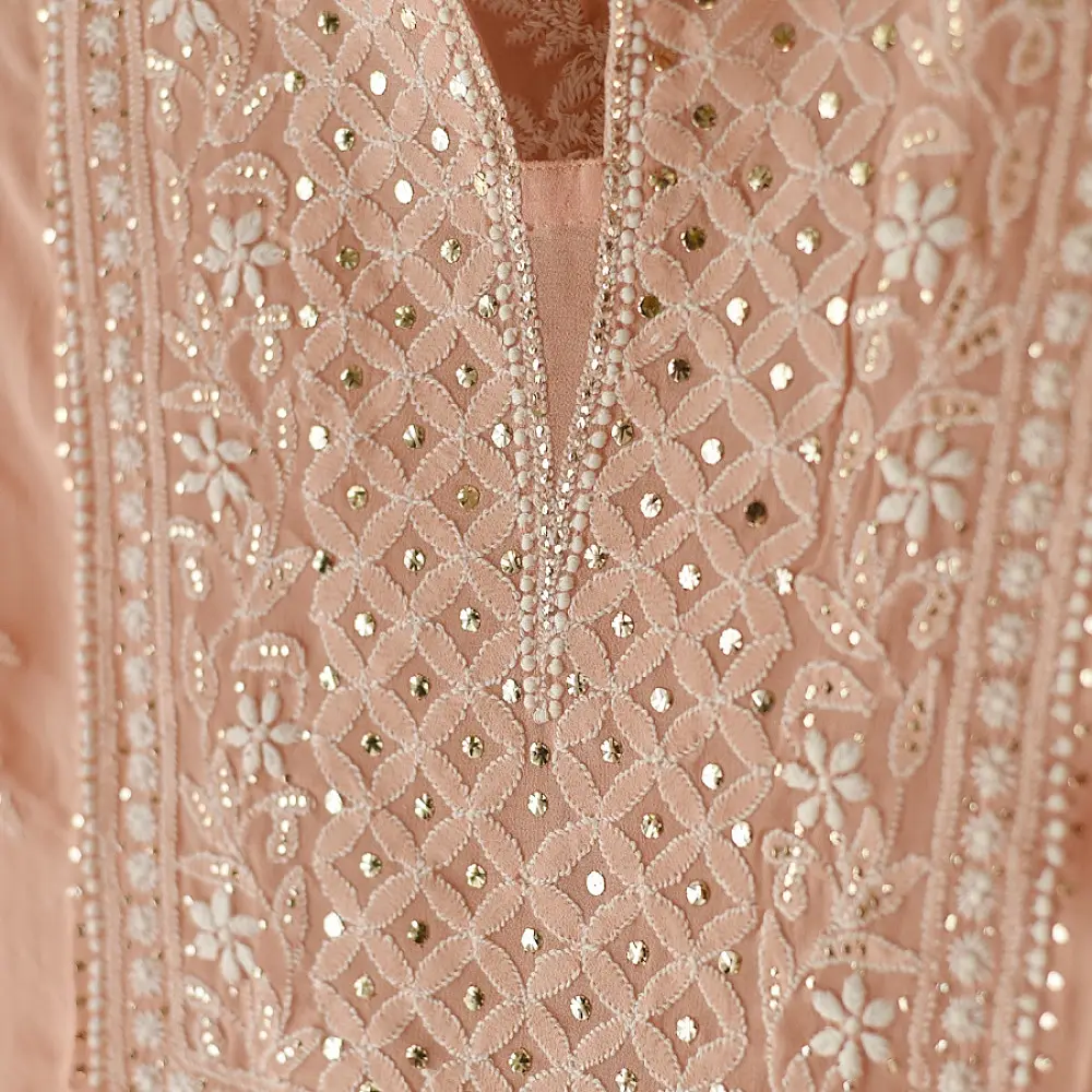 semi stitched viscose georgette kurti in delicate peach color featuring fine hand embroidered chikankari lattice yoke and all over floral motifs paired with a mukaish and lace detailed dupatta