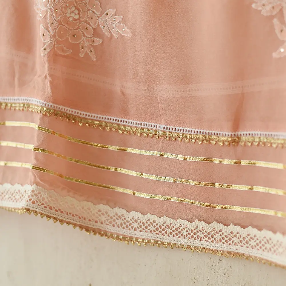 semi stitched viscose georgette kurti in delicate peach color featuring fine hand embroidered chikankari lattice yoke and all over floral motifs paired with a mukaish and lace detailed dupatta