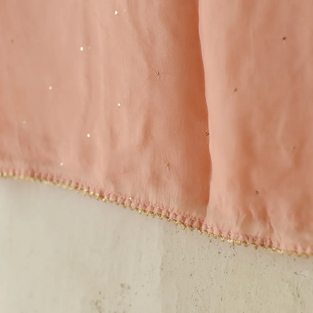 semi stitched viscose georgette kurti in delicate peach color featuring fine hand embroidered chikankari lattice yoke and all over floral motifs paired with a mukaish and lace detailed dupatta