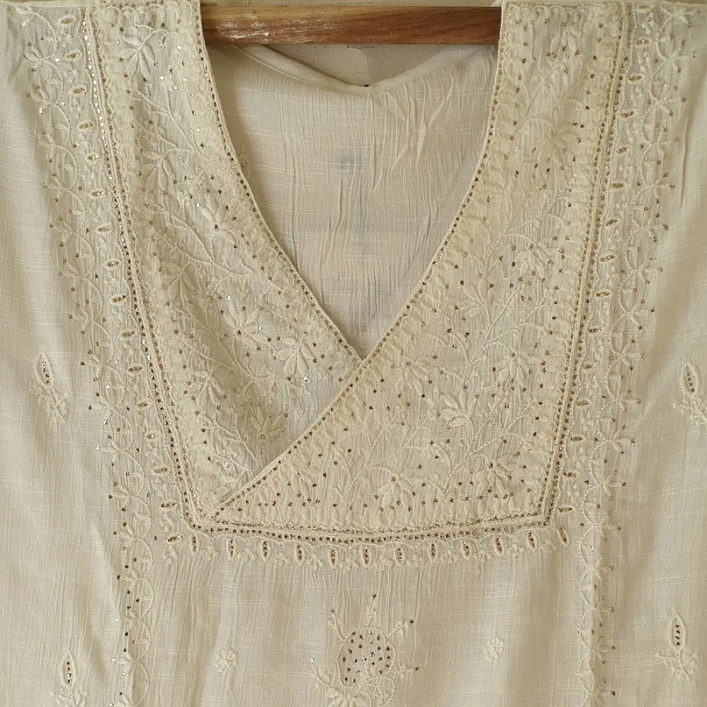 semi stitched viscose slub kurti with elegant embroidery panel design and dupatta with mukaish highlights in ethereal ivory color