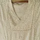 semi stitched viscose slub kurti with elegant embroidery panel design and dupatta with mukaish highlights in ethereal ivory color