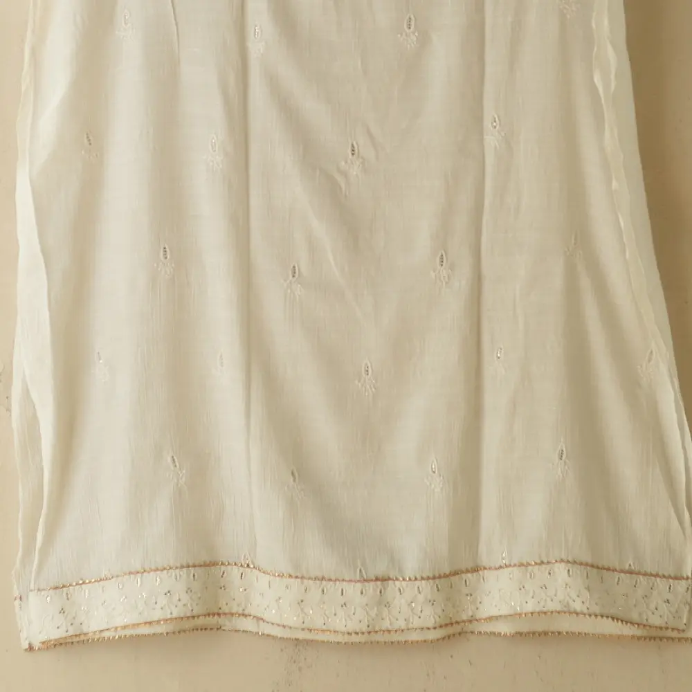 semi stitched viscose slub kurti with elegant embroidery panel design and dupatta with mukaish highlights in ethereal ivory color