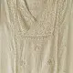 semi stitched viscose slub kurti with elegant embroidery panel design and dupatta with mukaish highlights in ethereal ivory color