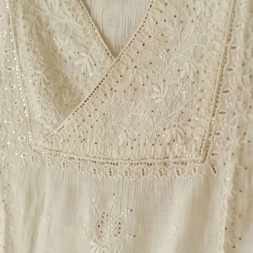 semi stitched viscose slub kurti with elegant embroidery panel design and dupatta with mukaish highlights in ethereal ivory color