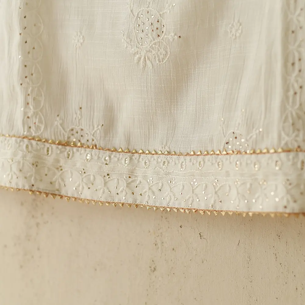 semi stitched viscose slub kurti with elegant embroidery panel design and dupatta with mukaish highlights in ethereal ivory color