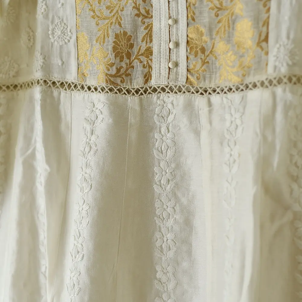 semi stitched pure silk chanderi kurti in off white with intricate hand embroidered resham chikankari and metallic gold brocade yoke and sleeve cuff details