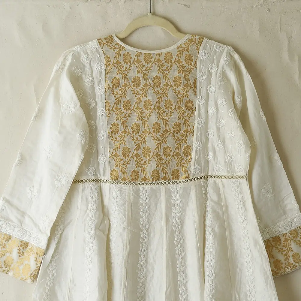 semi stitched pure silk chanderi kurti in off white with intricate hand embroidered resham chikankari and metallic gold brocade yoke and sleeve cuff details