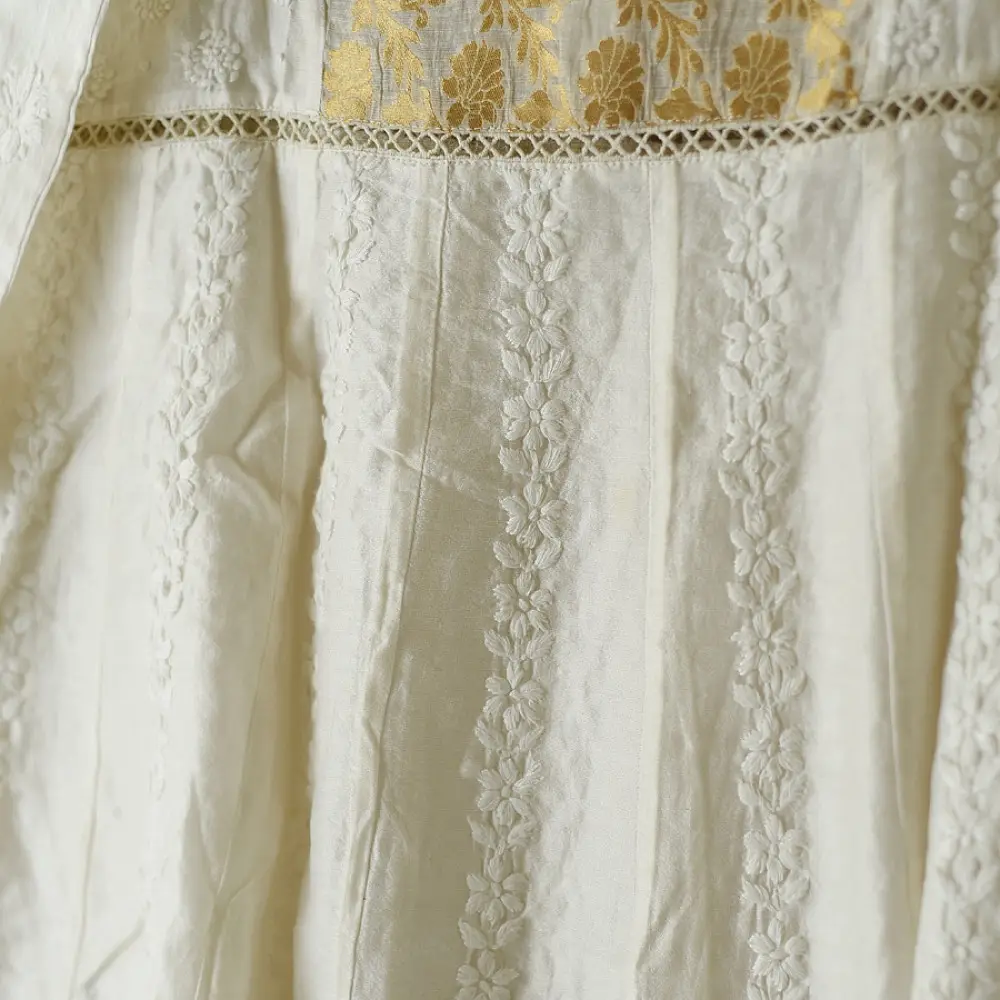 semi stitched pure silk chanderi kurti in off white with intricate hand embroidered resham chikankari and metallic gold brocade yoke and sleeve cuff details