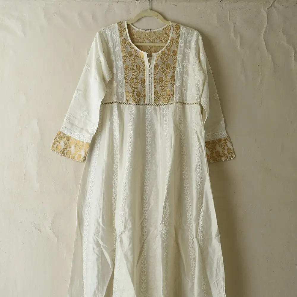semi stitched pure silk chanderi kurti in off white with intricate hand embroidered resham chikankari and metallic gold brocade yoke and sleeve cuff details