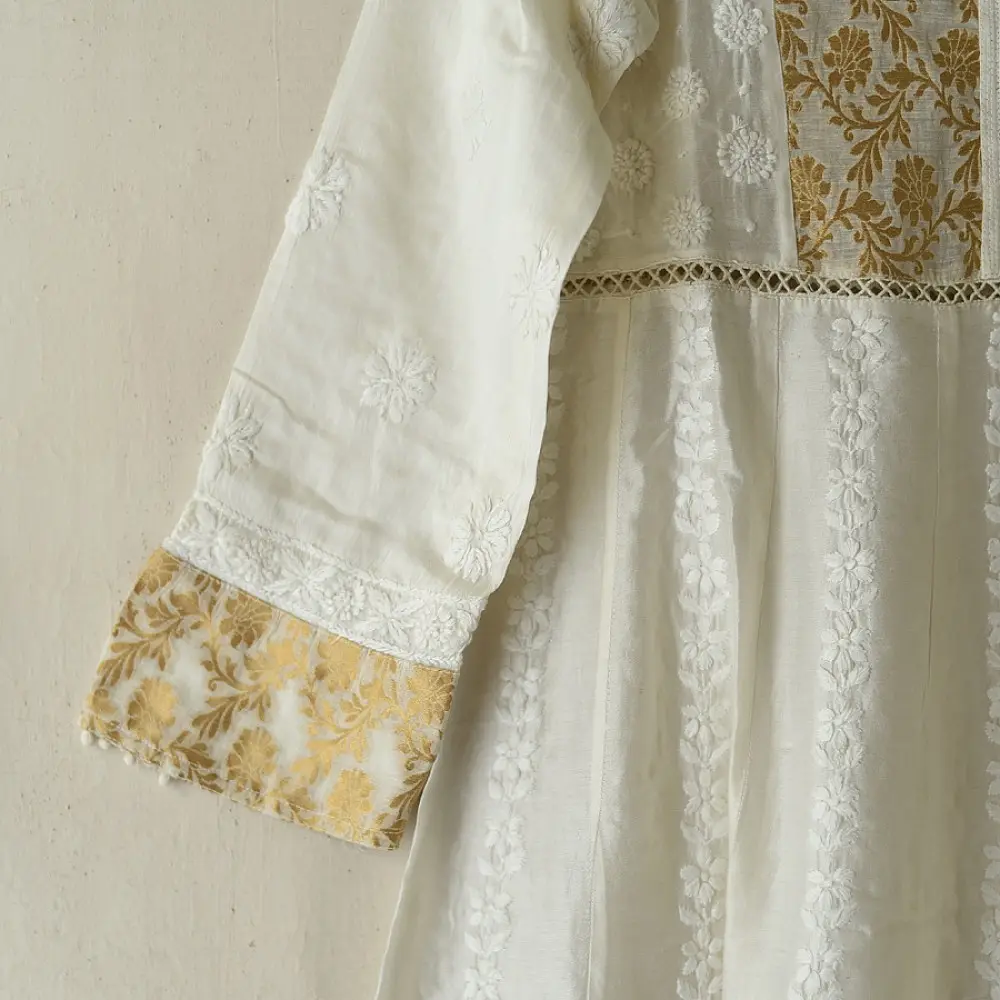 semi stitched pure silk chanderi kurti in off white with intricate hand embroidered resham chikankari and metallic gold brocade yoke and sleeve cuff details