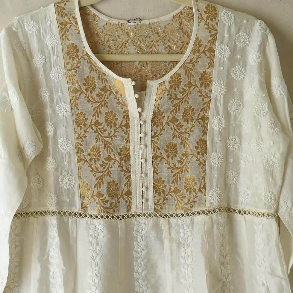 semi stitched pure silk chanderi kurti in off white with intricate hand embroidered resham chikankari and metallic gold brocade yoke and sleeve cuff details
