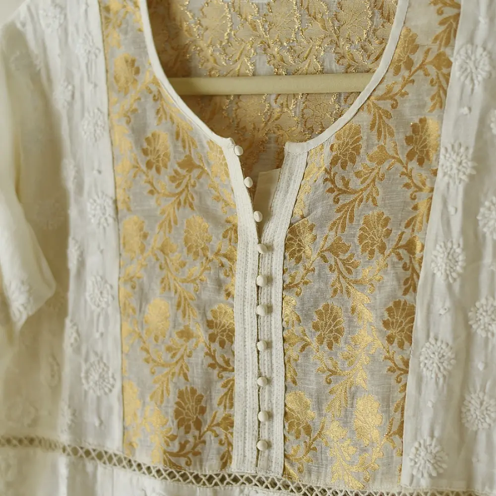 semi stitched pure silk chanderi kurti in off white with intricate hand embroidered resham chikankari and metallic gold brocade yoke and sleeve cuff details
